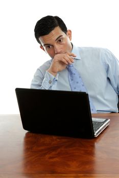 Man sitting at his desk with laptop thinking deeply