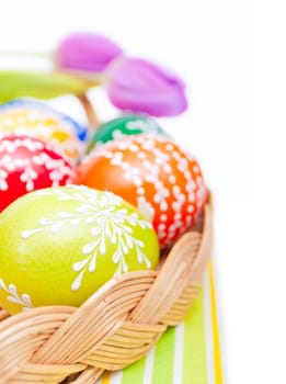 Easter Hand Painted Eggs in Basket on Tablecloth Isolated on White