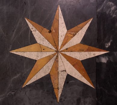 A star pattern on a marble floor.