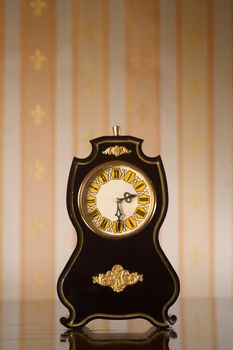 Black vintage clocks with scratches on wallpaper background