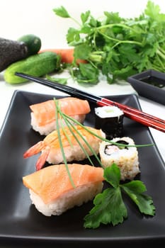 variety of sushi with parsley and chives