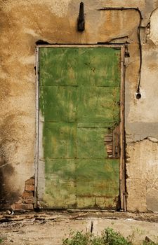 Old green wooden grungy door 