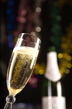 Champagne glass, blurred bottle on background 