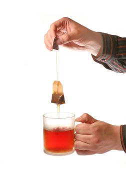 Mans hands holding tea cup and teabag isolated on white background