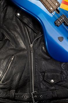 Close-up of a black leather jacket with guitar