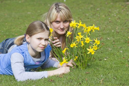  young woman and little girl in the park on a warm spring day