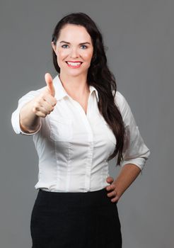 Portrait of successful beautiful business woman giving thumbs up