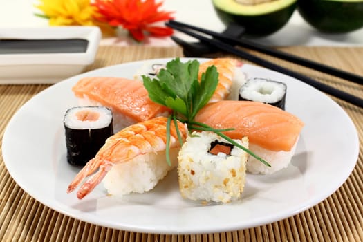 variety of sushi with parsley and chives