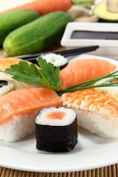 variety of sushi with parsley and chives