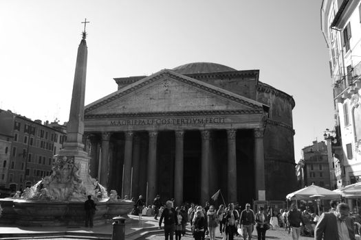 Tourists and Pantheon in Rome, Italy.  The Greek meaning of the word 'Pantheon' is an adjective meaning "to every god".  It was built around 126 AD by emporer Hadrian.
