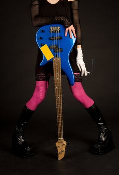 Close-up of girl with bass guitar and cigarette, studio shot  