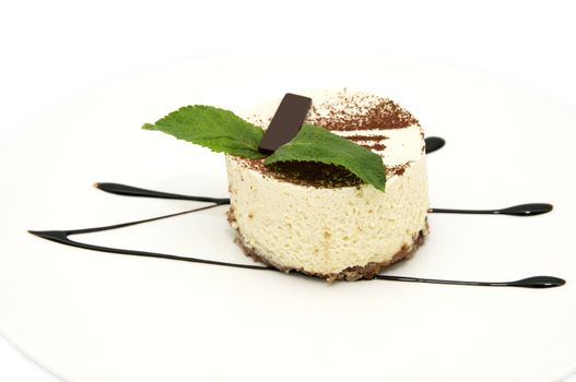 cream dessert garnished with mint on a white background