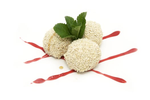 balls of ice cream with sesame seeds and strawberry jam