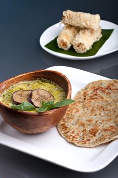 A dish of fresh Thai green curry soup with pancakes and appetizer.