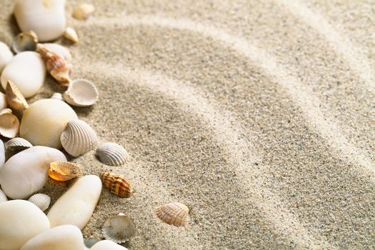 Sand with shells and stones. Beach composition with copy space