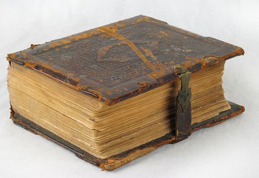 The ancient book in leather reliure on a light background