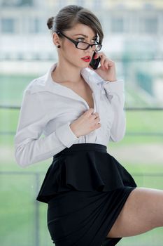 beautiful businesswoman with phone and laptop