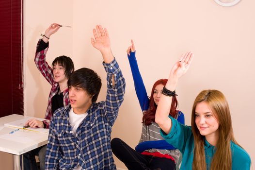 Students with hands raised, a motivated group