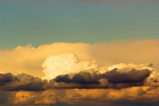 storm clouds illuminated by the setting sun at dusk