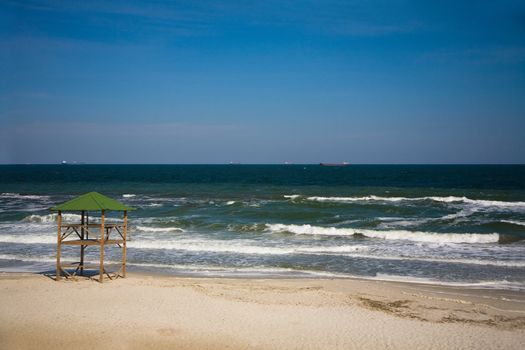 Empty beach, ships on horizon 