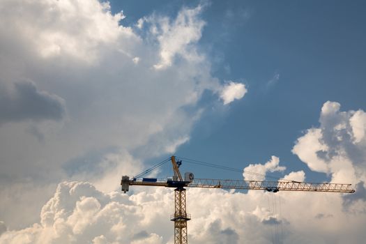 Construction crane over blue sky background 