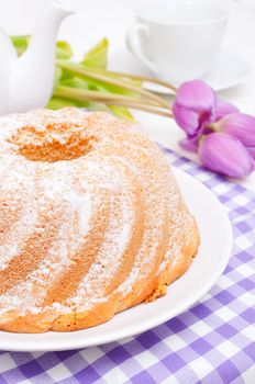 Guglhupf - Traditional Gugelhupf Sponge Cake and Tulip Flowers on Ta