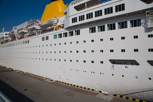 White passenger cruise ship with rescue boats in the port 