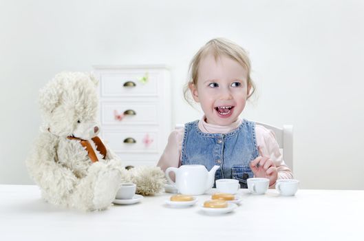 Child drink tea with bagels at home.