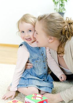 Mother and daughter playing in the children's cubes