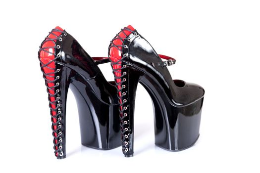 High heeled fetish shoes with corset lacing, isolated on white background with soft shadow 