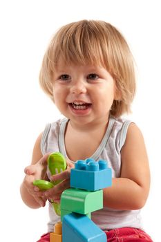 Laughing little boy playing with blocks, isolated on white background 