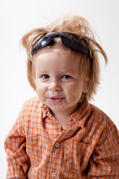 Portrait of cute little boy in sunglasses, studio shot 