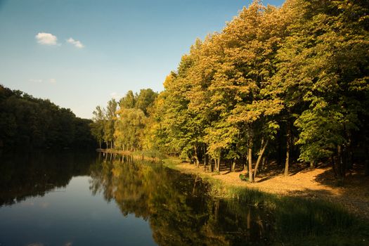 Autumn landscape with lake in the forest 