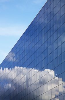 Modern office building and blue clear sky reflection 