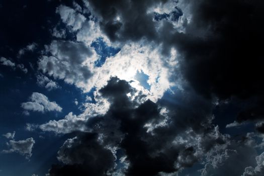 Dark cloudy sky with light rays 