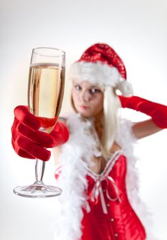 Mrs. Santa with champagne, focus on glass, studio shot 