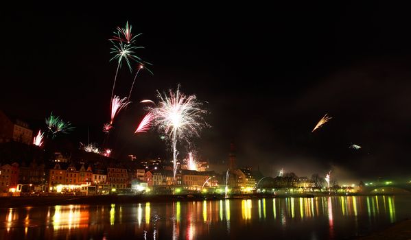 multicolor fireworks in small German town Cochem close to river