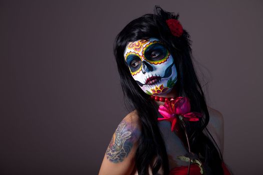 Sugar skull girl with red rose, professional body-art 