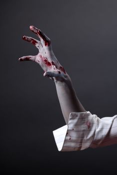 Creepy zombie hand, extreme body-art, studio shot 