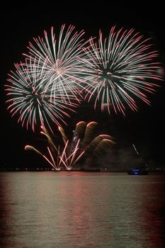 colorful huge fireworks display and reflection.