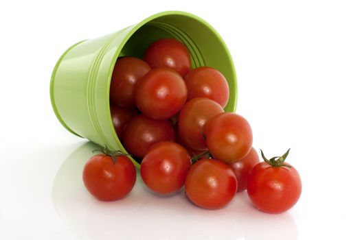 isolated red tomatoes in green basket