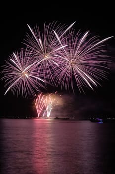 colorful huge fireworks display and reflection.