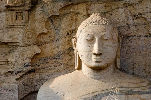 Buddha face with ornamental stone background, Polonnaruwa, Sri Lanka