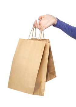 Two paper bags in a woman hand isolated over white background