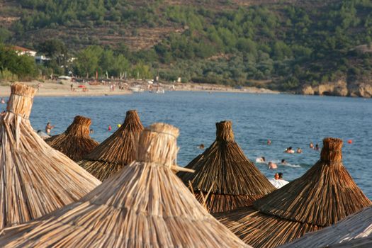 Umbrellas on Potos beach (Thassos) at sunset