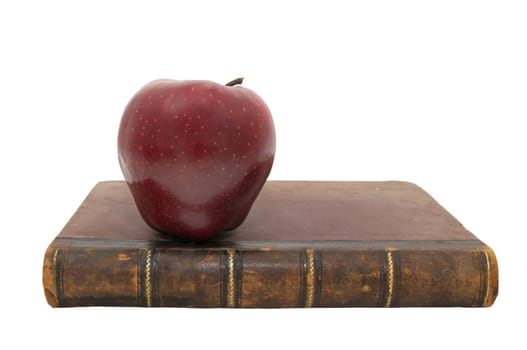 book and an apple on a white background