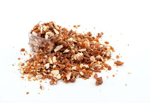 Caramelized crumbled Almonds for topping on white background