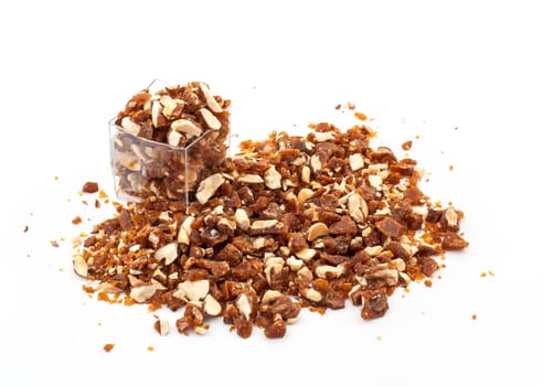 Caramelized crumbled Almonds for topping on white background