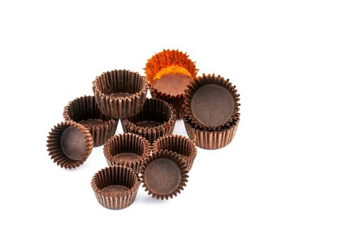 Brown chocolate rounded baking paper for muffin and pastry cups on white background