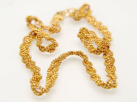 Yellow gold jewellry, isolated towards white background